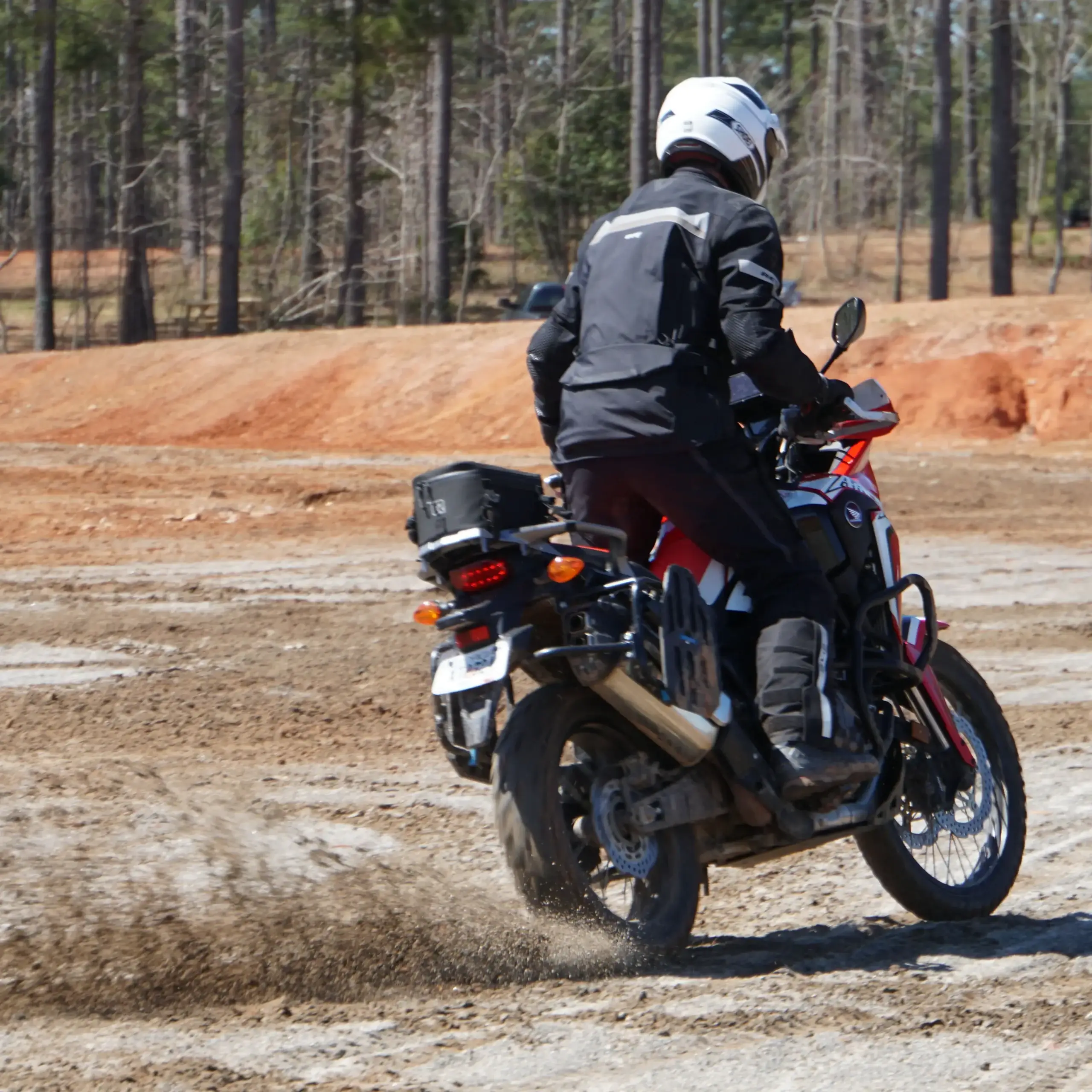 Bret Tkacs slides the rear tire of his Honda Africa Twin across red-clay ground, Georgia