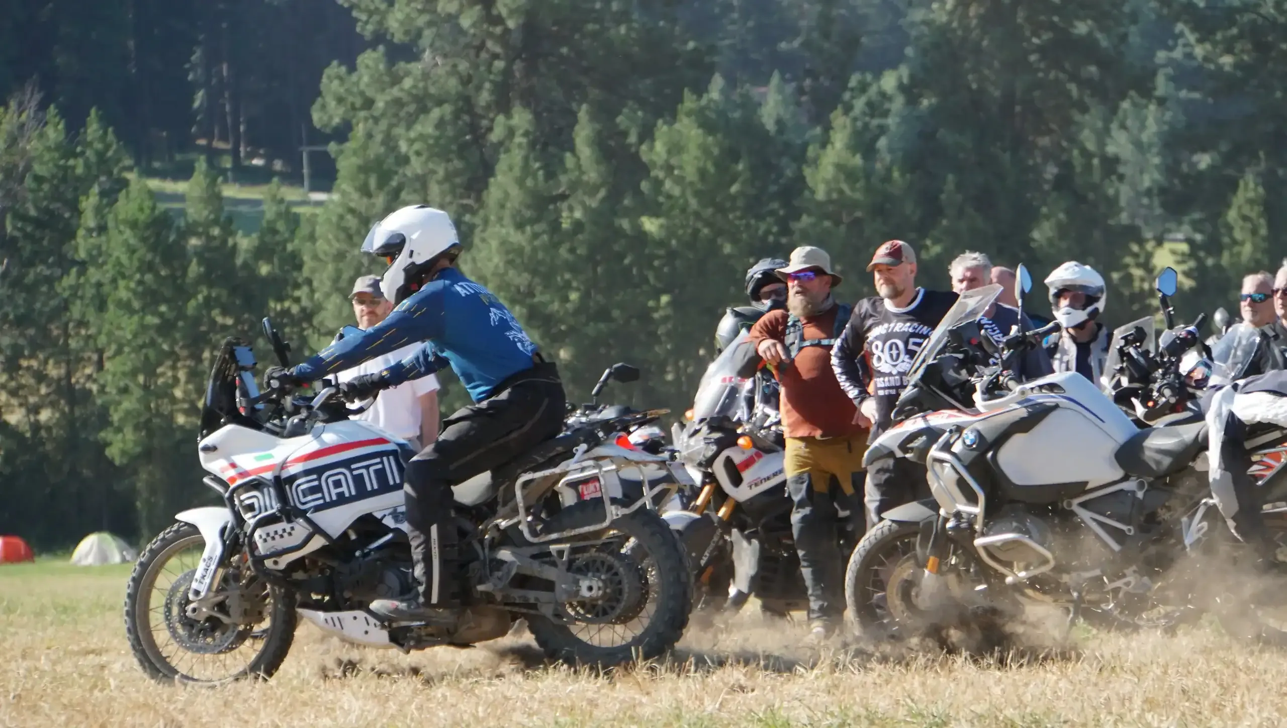 Bret Tkacs brakes hard on his Ducati as a line of students watches, Oregon