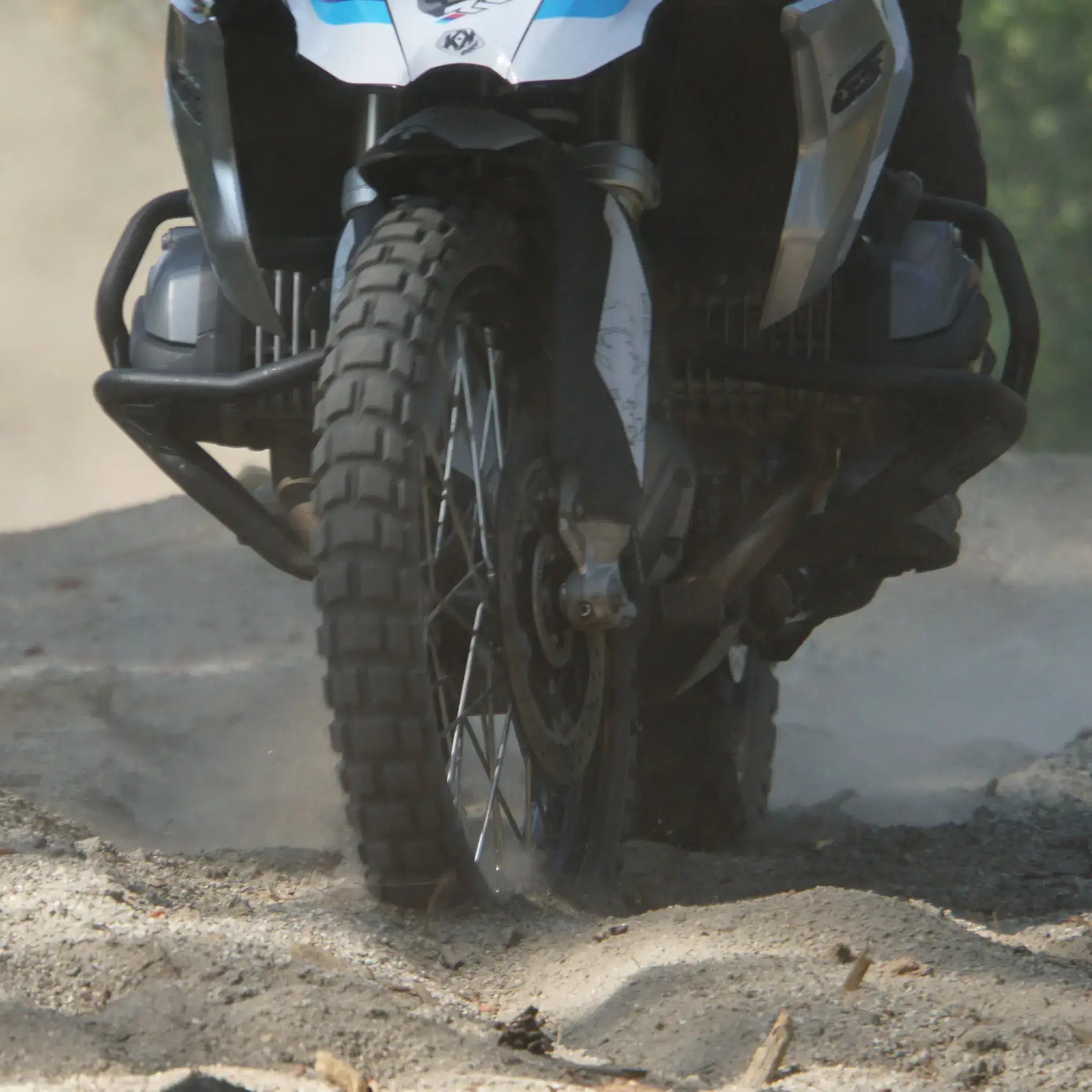 A Shinko 804 front tire on a BMW adventure bike kicks up sand, Washington